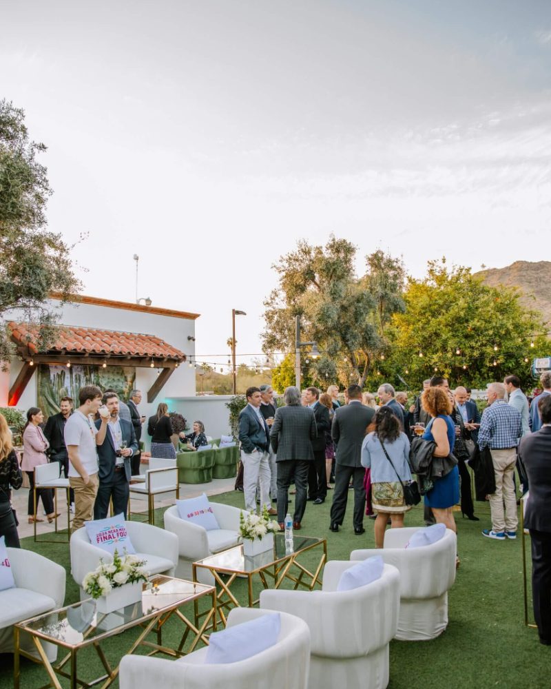 White lounge furniture and gold tables at an outdoor evening event