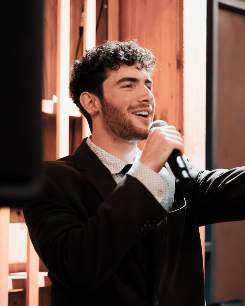 DJ singing into a microphone at a wedding reception