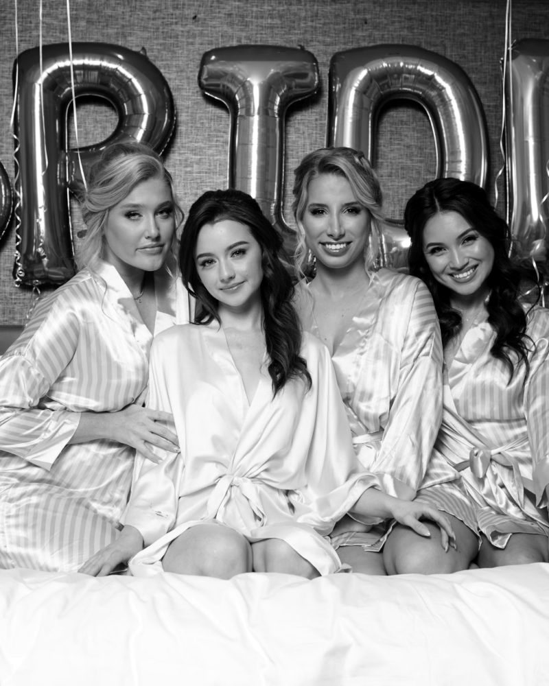Bride and bridesmaids in matching robes before the wedding