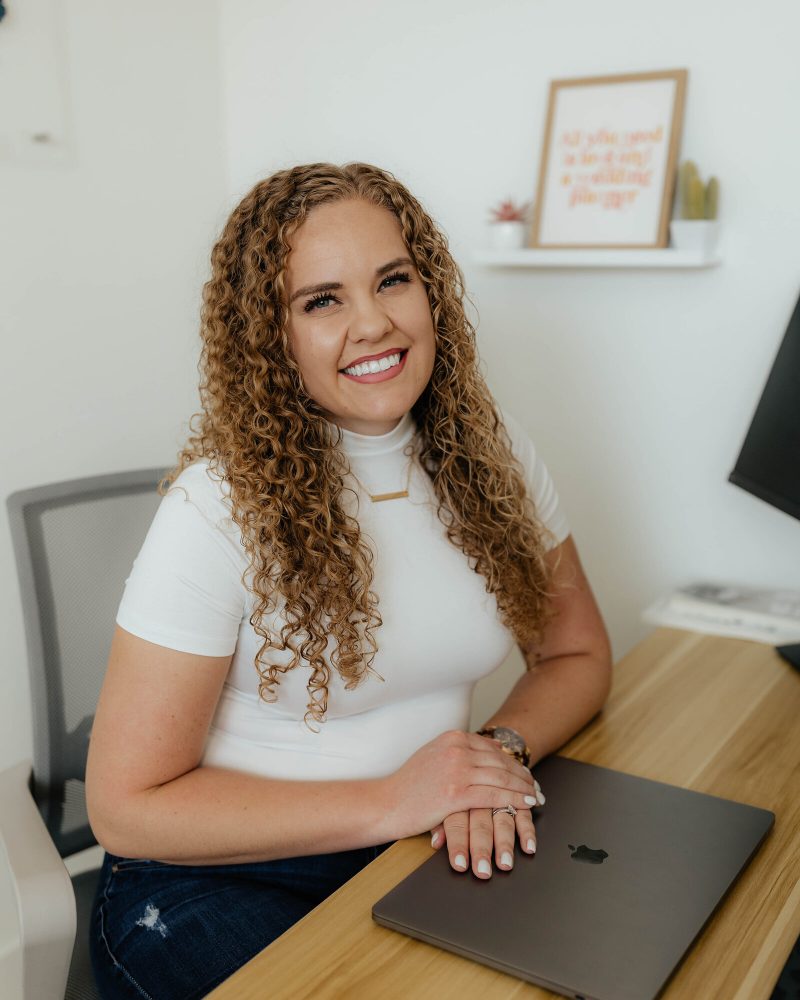 Let’s Talk Eventz planner smiling at her desk