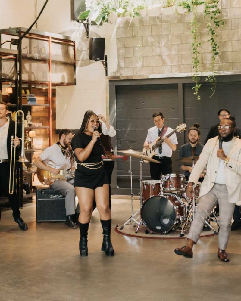 Lucky Devils Band performing with horns, guitar and drums